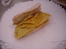 Un «cinque e cinque» aperto: la pagnottella «francesina» con dentro una fetta di torta di ceci. Spuntino da operai del porto di Livorno: dagli anni Trenta, 5 centesimi di pane e 5 di torta.